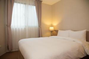 Postel nebo postele na pokoji v ubytování The Koos Hotel Dahu