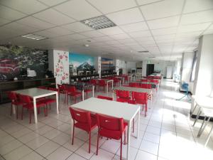 a dining room with tables and red chairs at Chang Ti Metropolis Commercial Hotel in Zhongli