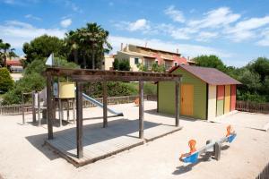 a playground with a play structure on a beach at Grupotel Playa Club in Son Xoriguer