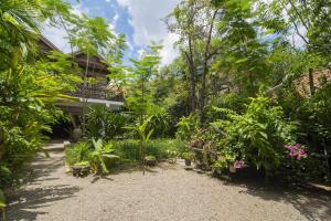 um jardim em frente a uma casa com plantas em Enkosa 4-Bedroom Wooden Luxury House em Siem Reap