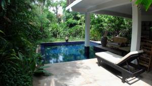 a swimming pool in the middle of a yard at Enkosa 4-Bedroom Wooden Luxury House in Siem Reap