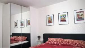 a bedroom with a bed and some pictures on the wall at Studio Muenster City in Münster