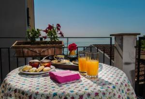 a table with a plate of food and orange juice at B&b Rosaria Amalfi Coast in Vietri sul Mare