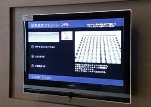 a television screen with a screenshot of a building at Akihabara Washington Hotel in Tokyo