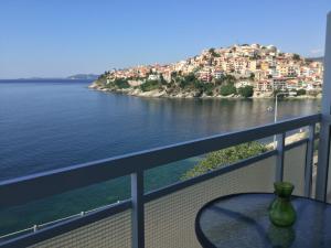 a table on a balcony with a view of the water at Traveler Homes 2 in Kavála