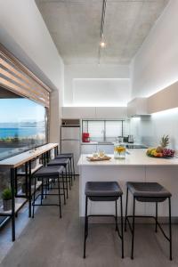 a kitchen with a large island with bar stools at Idolio Suite in Hersonissos