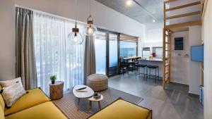 a living room with a yellow couch and a table at Idolio Suite in Hersonissos