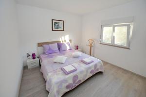 a bedroom with a large bed and a window at Apartment Palma in Bibinje