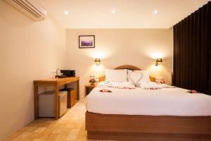 Ένα ή περισσότερα κρεβάτια σε δωμάτιο στο At Samui Boutique Hotel