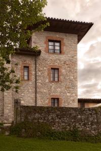 a stone building with windows on top of a stone wall at Hotel Villa Miramar in Po +19 photos