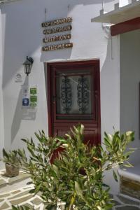 a door in a building with a plant in front of it at Porto Vlastos in Agios Ioannis