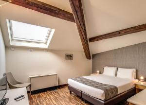 a bedroom with a bed and a window at Albergo Firenze in Como
