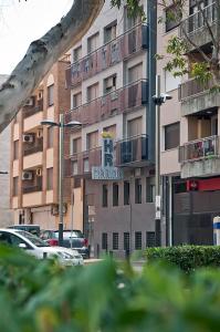 a tall building with a sign for a hotel at Hotel Marina in Peniscola