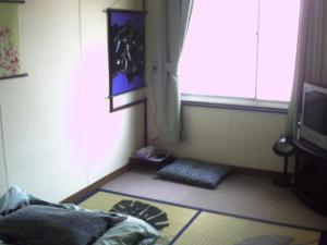 a living room with a window and a television at Tama Ryokan in Tokyo