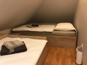 two beds in a small room with white sheets at Vila Lesce apartments in Lesce