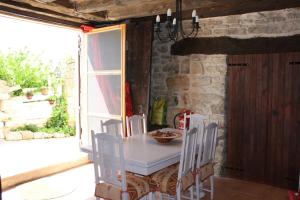 a dining room with a table and chairs and a window at Les Cavallerisses in Guialmons