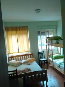 a bedroom with two bunk beds and a table at The Green Apartment in Golem