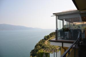 a balcony of a building with a view of the water at Hotel La Terrazzina in Gargnano