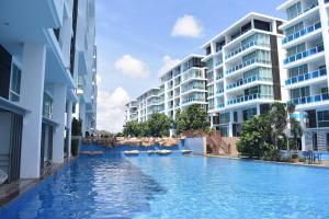 a swimming pool in the middle of two buildings at My resort Huahin by D511 in Hua Hin
