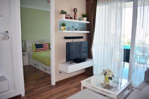 a small living room with a tv and a bed at My resort Huahin by D511 in Hua Hin +40 photos