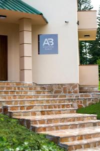 a sign on the side of a building with stairs at Apartmani Bijelic in Žabljak