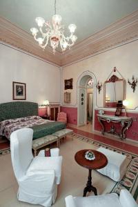 a large bedroom with a bed and a chandelier at B&B Flora House in Salerno