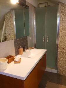 a bathroom with a sink and a shower at Tyrrhenian Sea Apartment in Torre Faro