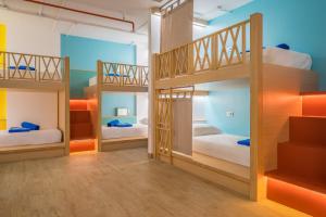 a bunk bed room with three bunk beds at Lub d Cambodia Siem Reap in Siem Reap