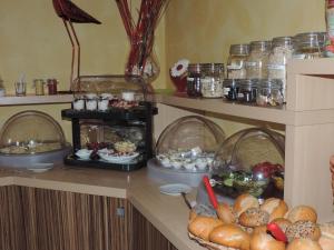 a table with a bunch of bread and other foods at Pension Achteridyll in Ueckeritz