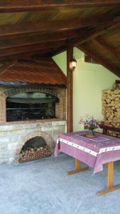 a picnic table in front of a brick fireplace at Apartment Petra in Mrkopalj