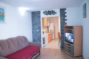 a living room with a couch and a tv at Apartment Lorena in Sevid