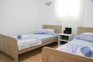 a room with three beds and a window at Apartment Lorena in Sevid