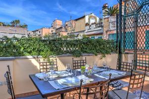 a table with chairs and plates on a balcony at Orsoline Boutique Apartments - Best position in Rome in Rome