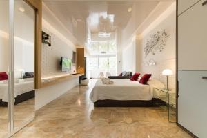 a bedroom with a large bed and a mirror at Suites Garden Loft Munch in Las Palmas de Gran Canaria