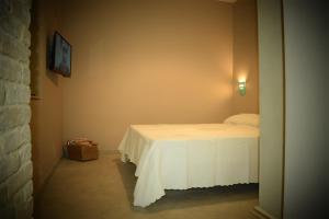 A bed or beds in a room at Corte Boero Bed&Breakfast