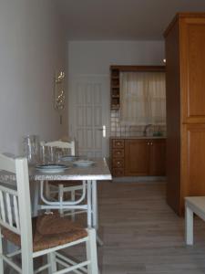 a kitchen with a table and chairs in a room at Vasiliki's House in Naxos Chora