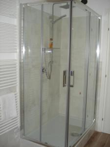 a shower with a glass door in a bathroom at Globetrotter in Formia