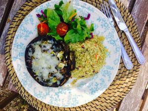 a plate of food with rice and vegetables on a table at Casa do Páteo in Aldeia do Meco