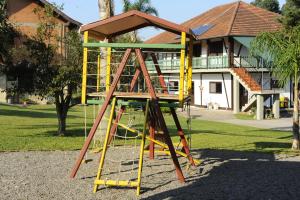 a playground with a slide in front of a house at Pousada Bauernhof in Nova Petrópolis +22 photos