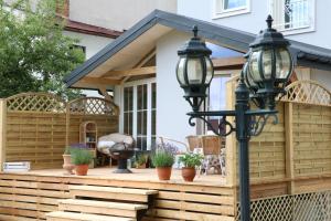 a deck with a pergola and a lamp at Apartments Casablanca in Poprad