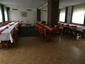 a dining room with tables and chairs in a building at Zur Krone in Seelze