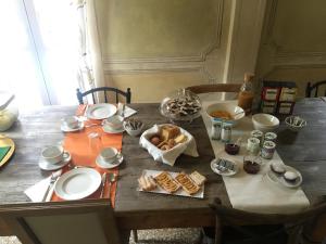 a wooden table with bread and other food on it at Villa Laura in Cocconi