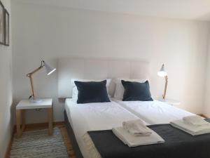 a hotel room with a bed and two lamps at Apartments Center Alfama in Lisbon