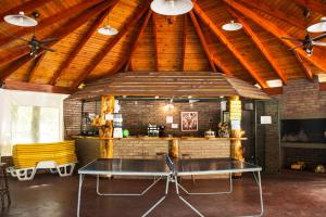 a ping pong table in the middle of a room at Cabañas Alpendorf in Villa General Belgrano