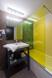 a bathroom with a sink and a shower at New Hotel Colon in Mataró