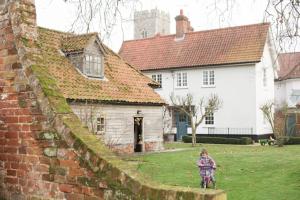 a child riding a bike next to a brick wall at The Old Rectory in Campsey Ash