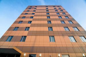 a tall building with the sky in the background at John Hotel in Queens