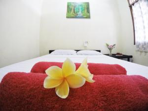 A bed or beds in a room at Bali Manik Beach Inn