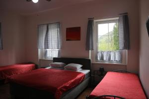 a bedroom with two beds and a window at Apartmány Lestarka in Kořenov