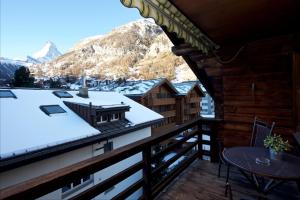 a balcony with a view of a snow covered mountain at Chalet Felderhof in Zermatt